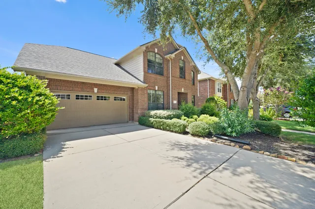 a front view of a house with a yard and a garage