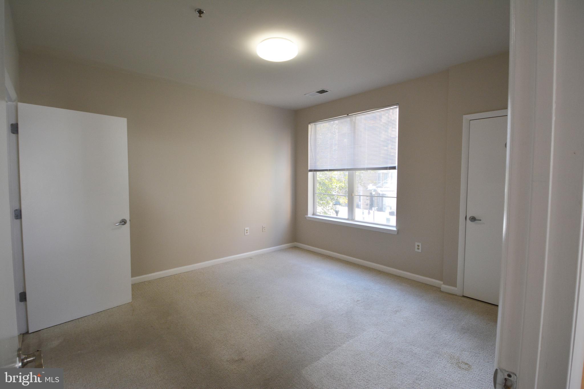 1201 East W Highway, Unit 238 Silver Spring, MD 20910 - Photo 17 of 18 a view of an empty room with a window