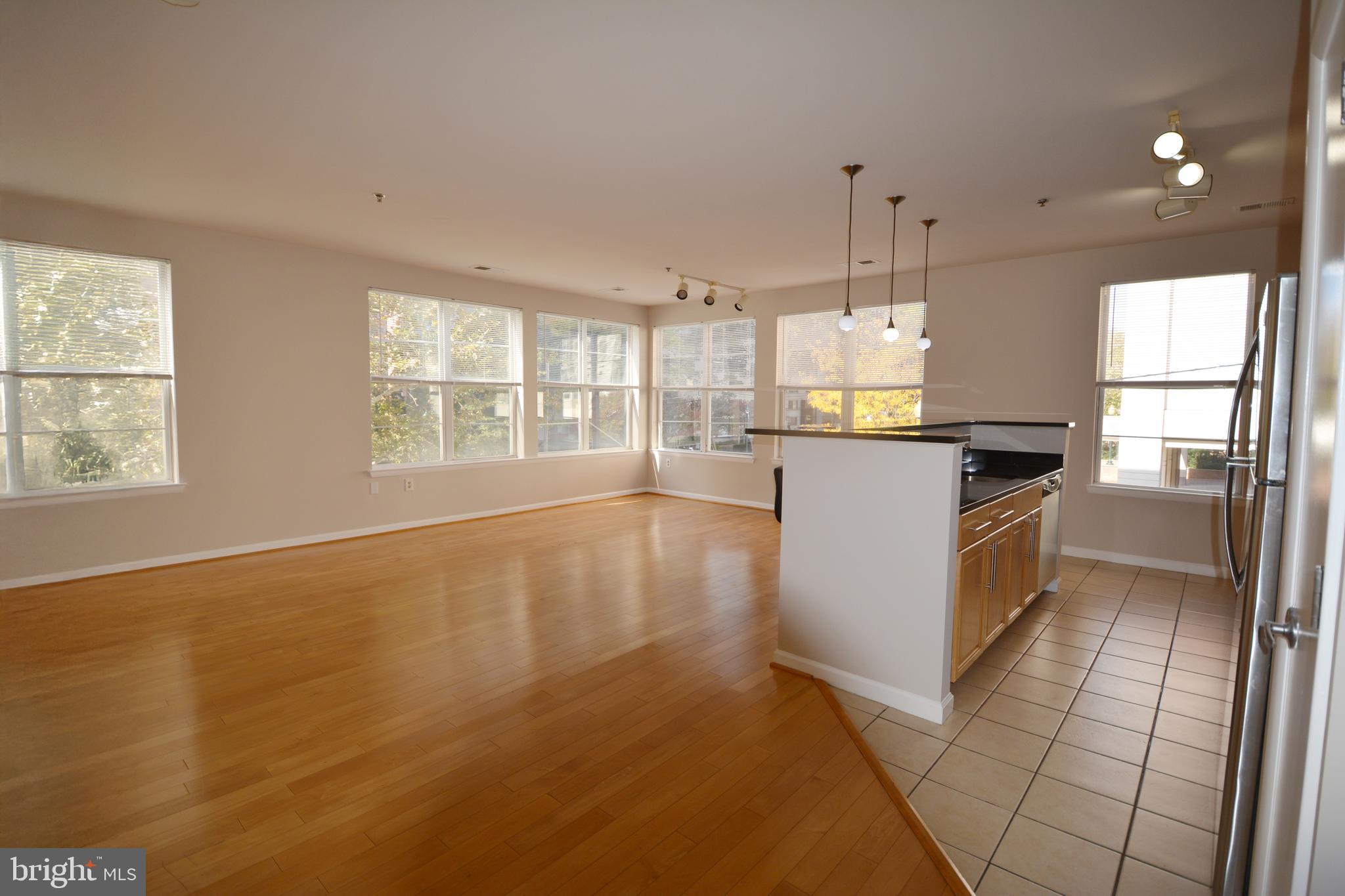 1201 East W Highway, Unit 238 Silver Spring, MD 20910 - Photo 8 of 18 a kitchen with stainless steel appliances granite countertop a stove a sink and a refrigerator