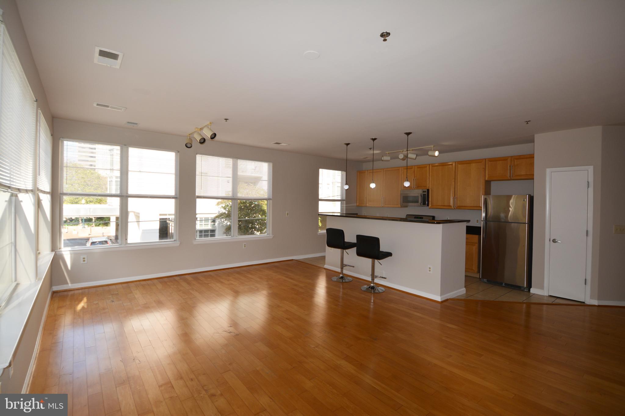 1201 East W Highway, Unit 238 Silver Spring, MD 20910 - Photo 10 of 18 wooden floor in an empty room with a window