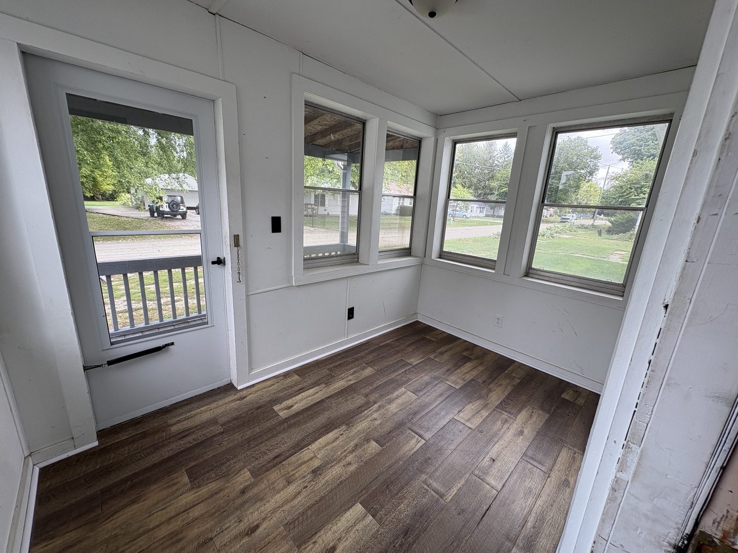 621 West Winthrop Street Earlville, IL 60518 - Photo 2 of 11 a view of an empty room with wooden floor and a window