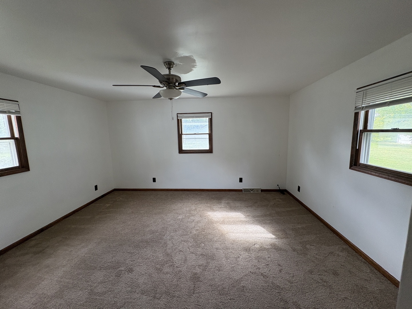 621 West Winthrop Street Earlville, IL 60518 - Photo 7 of 11 an empty room with windows and fan