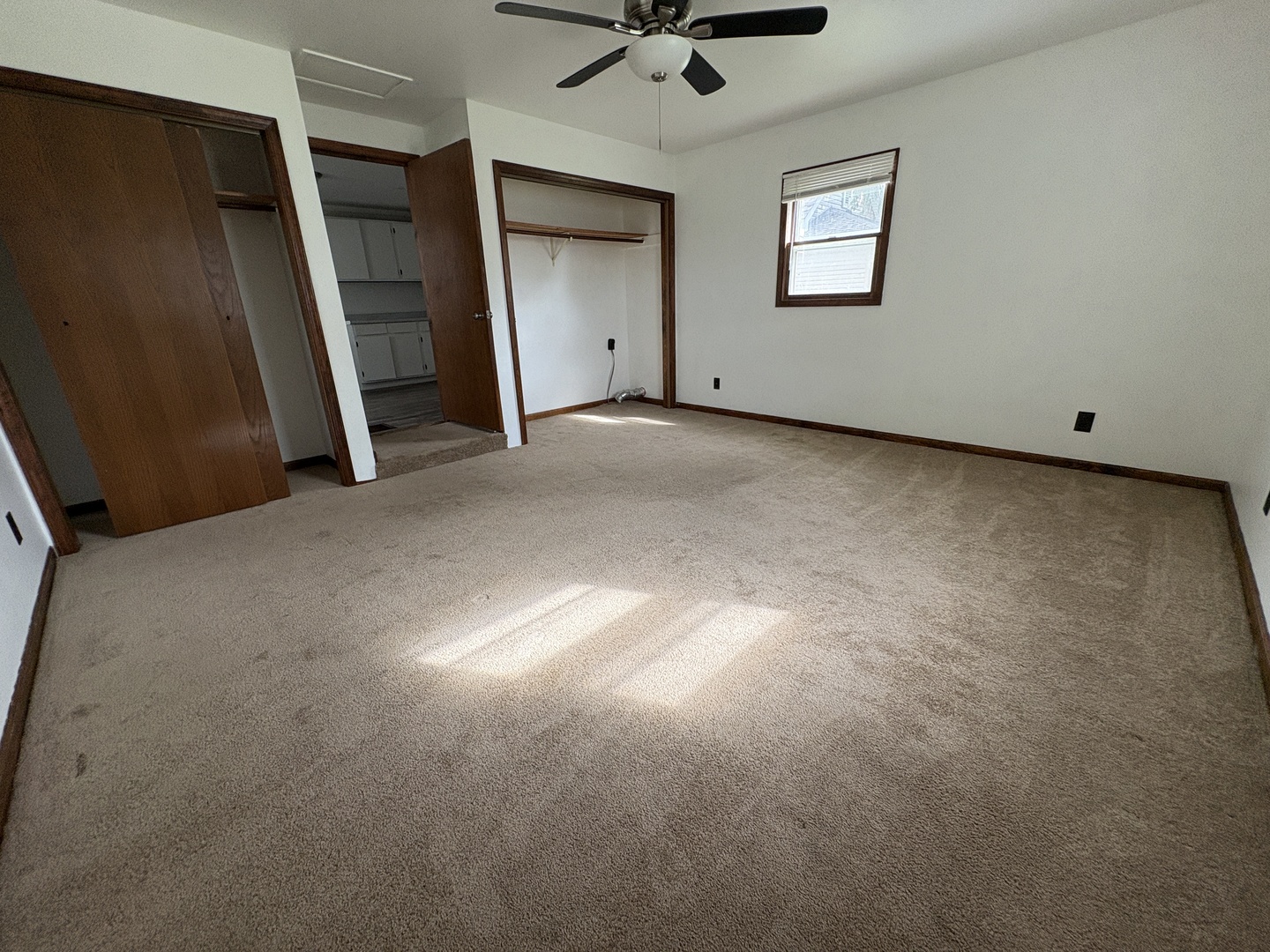 621 West Winthrop Street Earlville, IL 60518 - Photo 8 of 11 an empty room with windows and ceiling fan