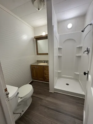 a bathroom with a toilet a sink and shower