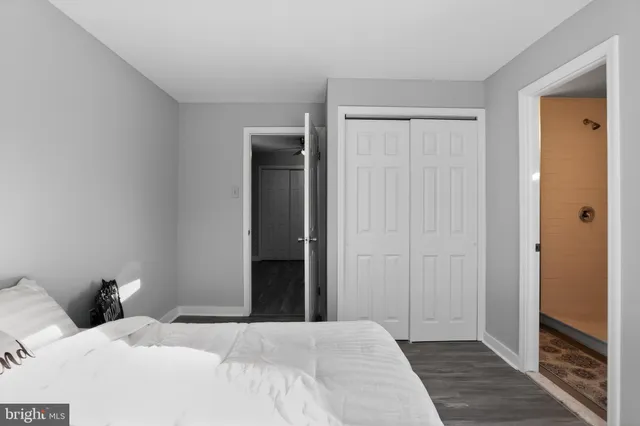 a bedroom with a bed and a mirror