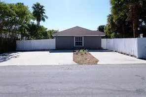 a front view of house with yard and trees