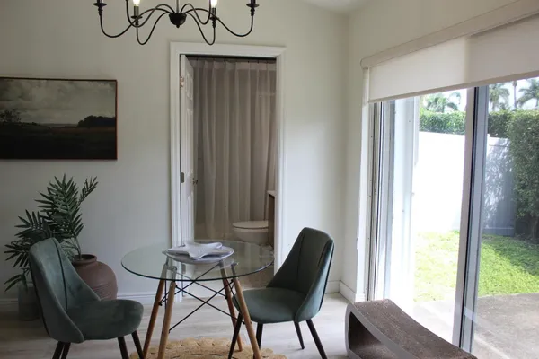 a bathroom with a granite countertop sink a mirror and toilet