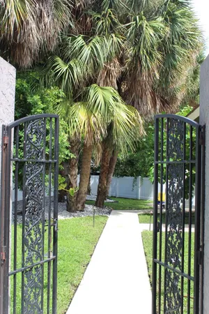 a view of a backyard with table and chairs with wooden fence