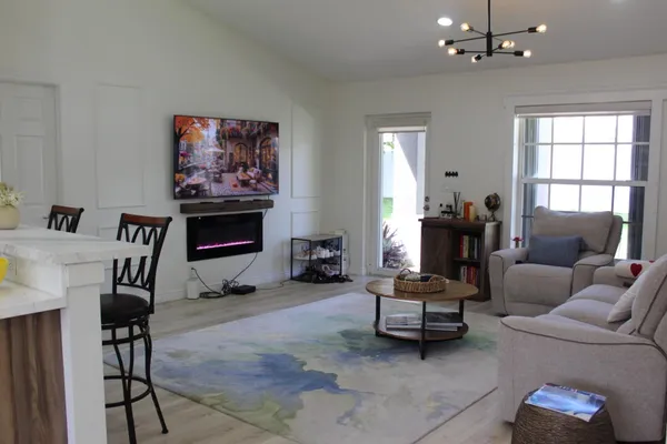 a kitchen with a sink a stove and chairs