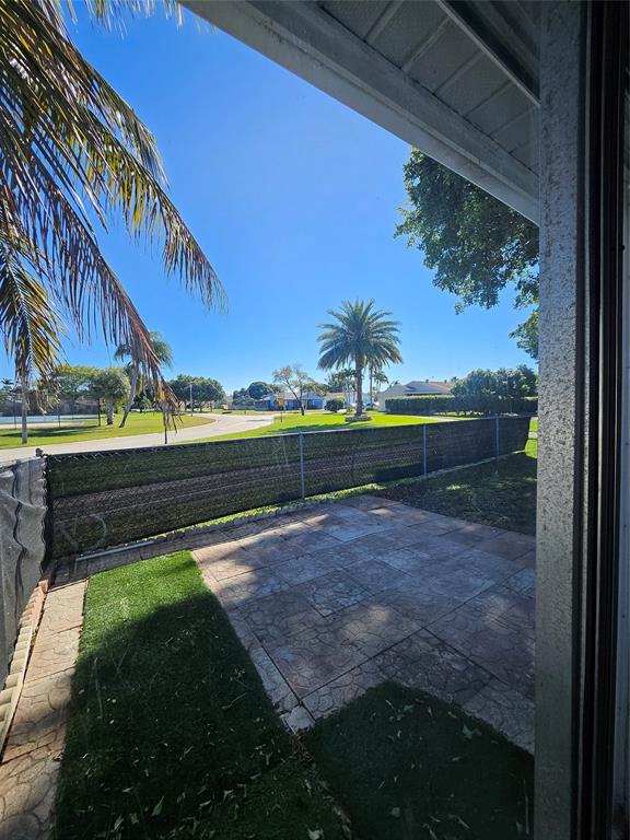 8290 Butterfield Lane Boca Raton, FL 33433 - Photo 16 of 38 a view of a lake with a house in the background