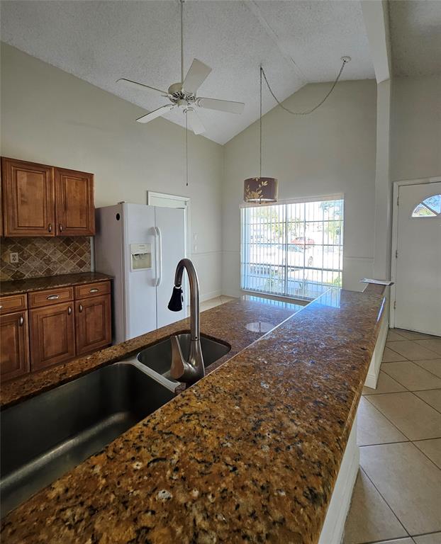 8290 Butterfield Lane Boca Raton, FL 33433 - Photo 17 of 38 a kitchen with granite countertop a stove a sink and a microwave