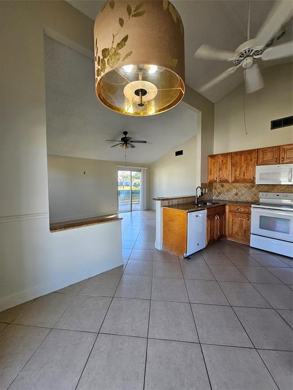 8290 Butterfield Lane Boca Raton, FL 33433 - Photo 19 of 38 a kitchen with stainless steel appliances granite countertop a stove a sink and a refrigerator