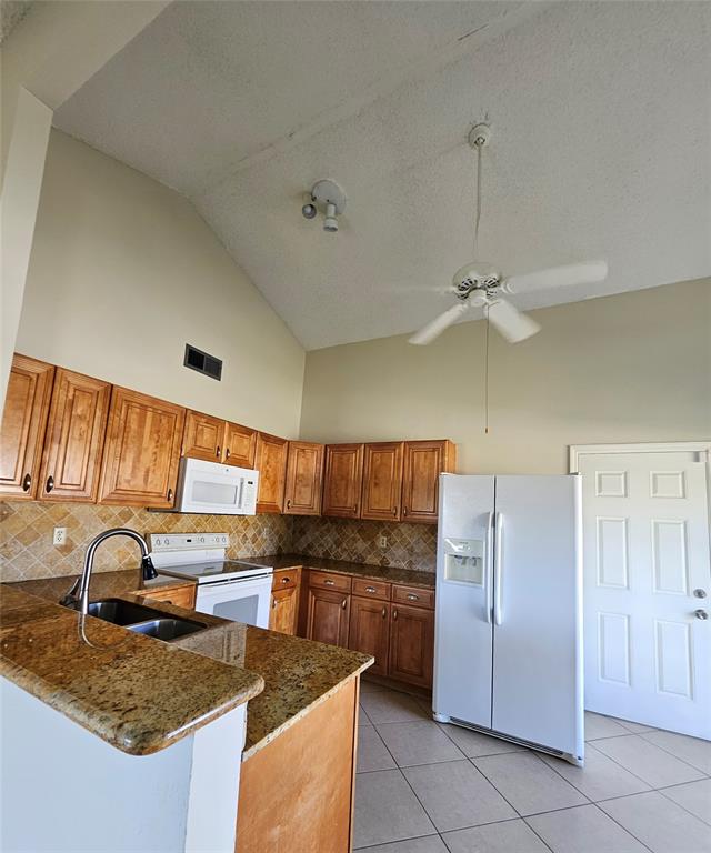 8290 Butterfield Lane Boca Raton, FL 33433 - Photo 20 of 38 a kitchen with a refrigerator a sink and cabinets