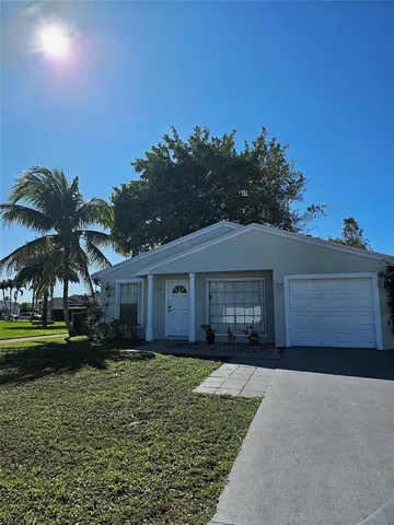 a view of a backyard of a house with a tree