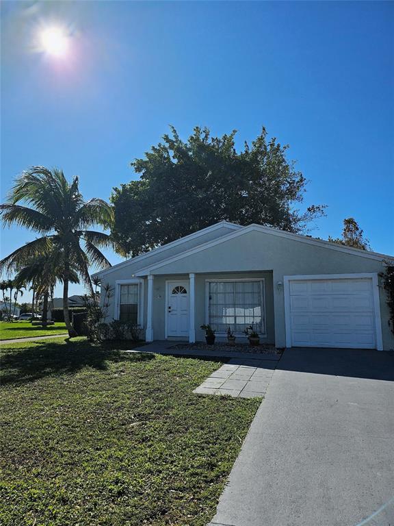 8290 Butterfield Lane Boca Raton, FL 33433 - Photo 4 of 38 a front view of a house with garden