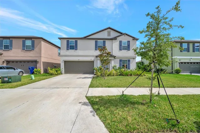 a view of a house with a yard and plants
