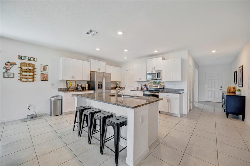 11112 Linden Depot Road San Antonio, FL 33576 - Photo 16 of 82 a kitchen with cabinets and chairs