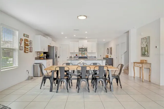 a spacious bedroom with a bed couch and a window
