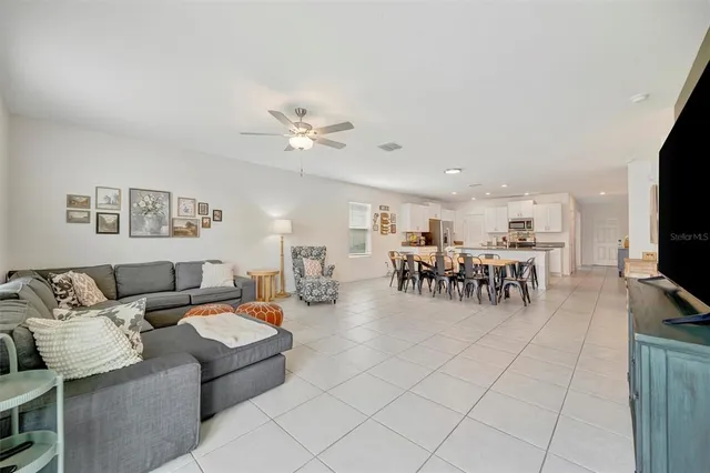a spacious bathroom with a granite countertop sink and a mirror