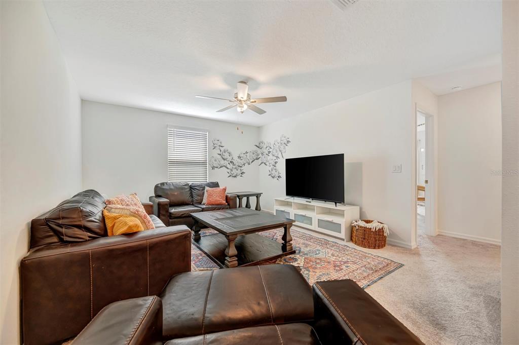 11112 Linden Depot Road San Antonio, FL 33576 - Photo 30 of 82 a living room with furniture and a flat screen tv