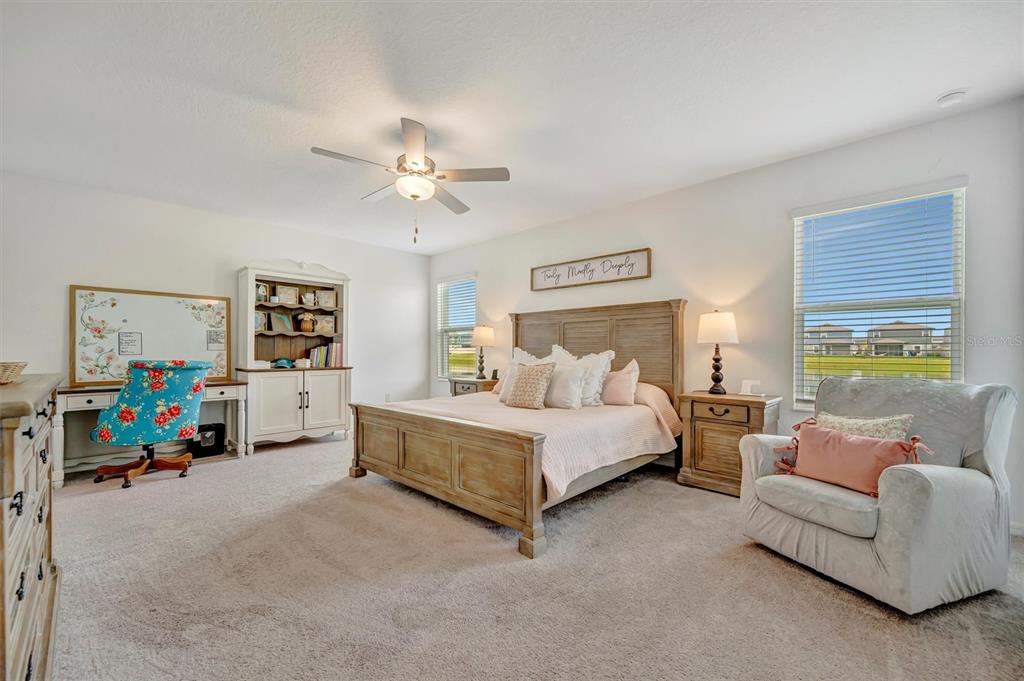 11112 Linden Depot Road San Antonio, FL 33576 - Photo 38 of 82 a spacious bedroom with a bed couch and a window