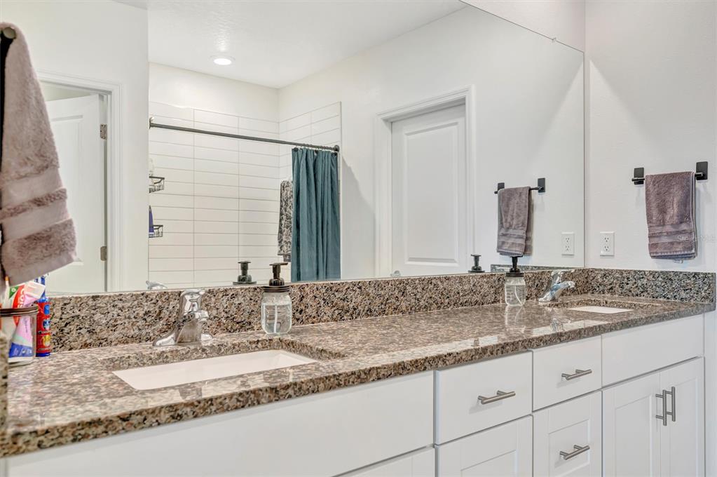 11112 Linden Depot Road San Antonio, FL 33576 - Photo 44 of 82 a bathroom with double vanity sinks and a mirror