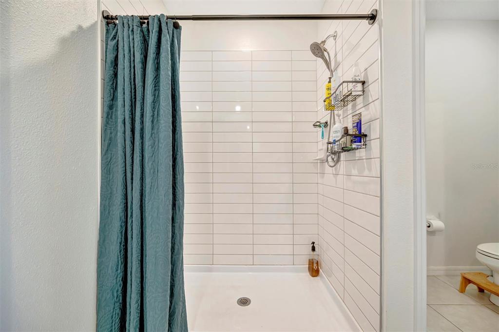11112 Linden Depot Road San Antonio, FL 33576 - Photo 45 of 82 a bathroom with a shower and a toilet