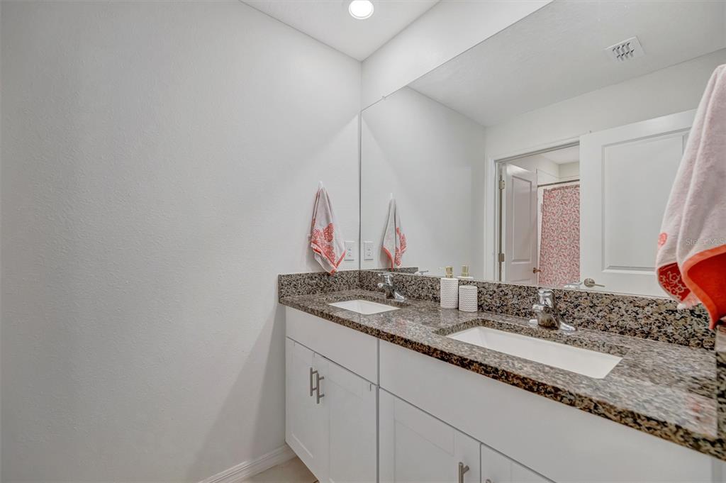 11112 Linden Depot Road San Antonio, FL 33576 - Photo 54 of 82 a bathroom with a granite countertop sink and a mirror