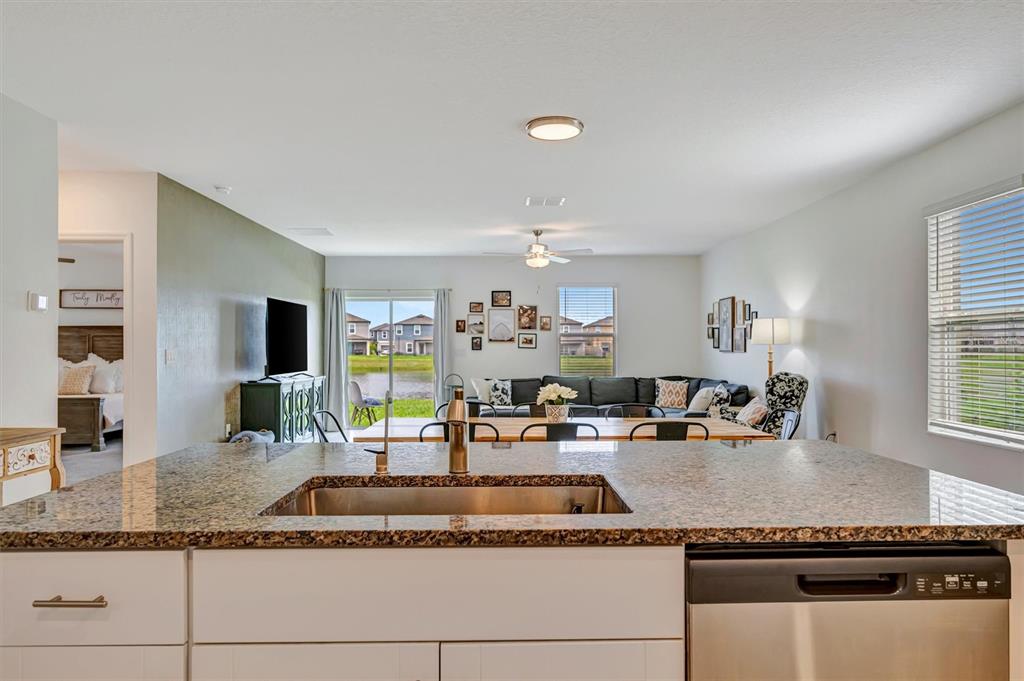 11112 Linden Depot Road San Antonio, FL 33576 - Photo 7 of 82 a kitchen with granite countertop a sink and cabinets