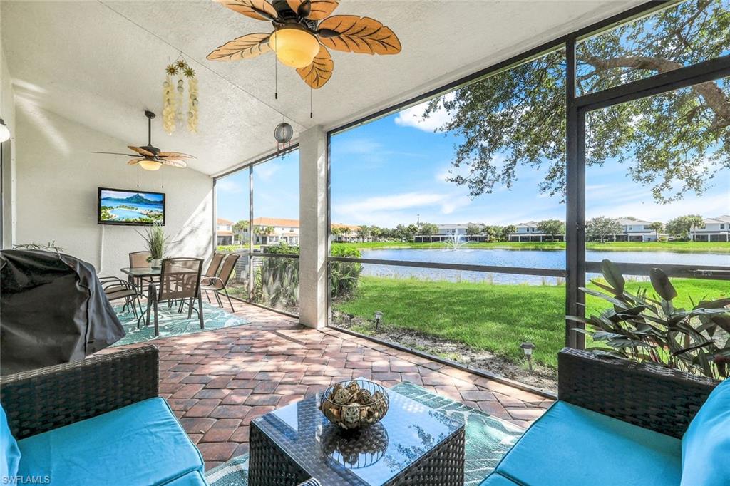 15239 Summit Pl Circle, Unit 246 Naples, FL 34119 - Photo 1 of 49 Sunroom / solarium with a ceiling fan, outdoor dining area, a water view, and a patio