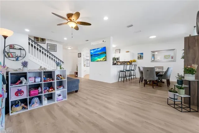 a living room with lots of furniture and white walls