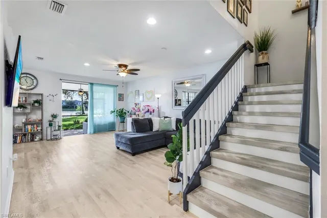 a living room with furniture and a potted plant