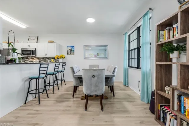 a view of a dining room with furniture and wooden floor