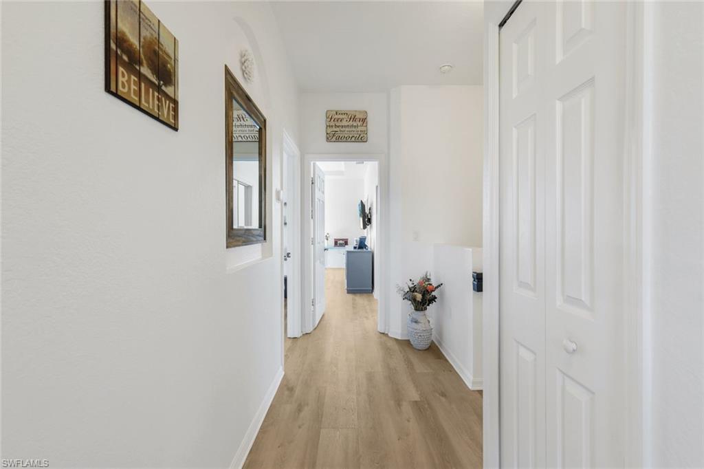15239 Summit Pl Circle, Unit 246 Naples, FL 34119 - Photo 21 of 49 Hall with light wood-style flooring and baseboards