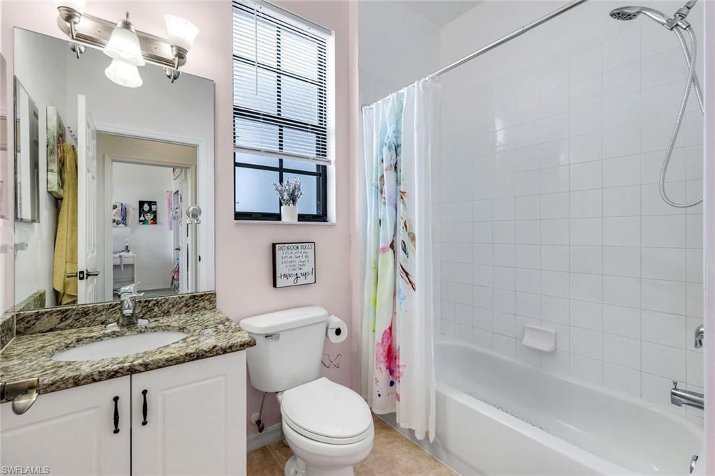 15239 Summit Pl Circle, Unit 246 Naples, FL 34119 - Photo 28 of 49 Bathroom with vanity, shower / bath combo with shower curtain, and light tile patterned flooring