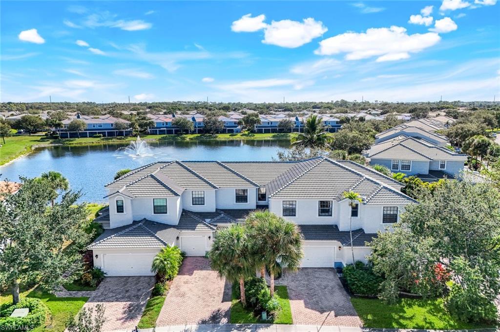 15239 Summit Pl Circle, Unit 246 Naples, FL 34119 - Photo 3 of 49 Aerial perspective of suburban area with a nearby body of water