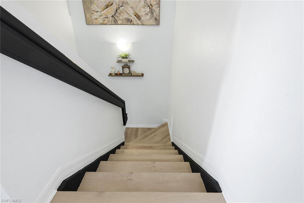 15239 Summit Pl Circle, Unit 246 Naples, FL 34119 - Photo 32 of 49 Stairway with baseboards