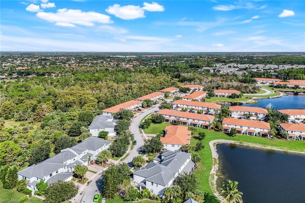 15239 Summit Pl Circle, Unit 246 Naples, FL 34119 - Photo 37 of 49 Aerial view of residential area with a large body of water