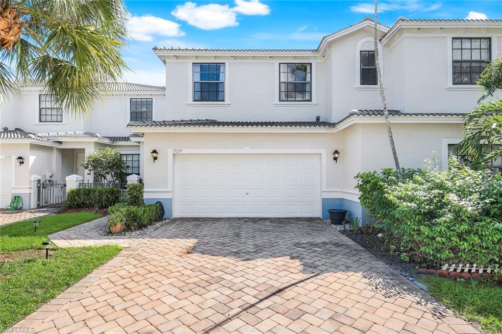 15239 Summit Pl Circle, Unit 246 Naples, FL 34119 - Photo 38 of 49 Mediterranean / spanish house with decorative driveway, an attached garage, stucco siding, and a tile roof
