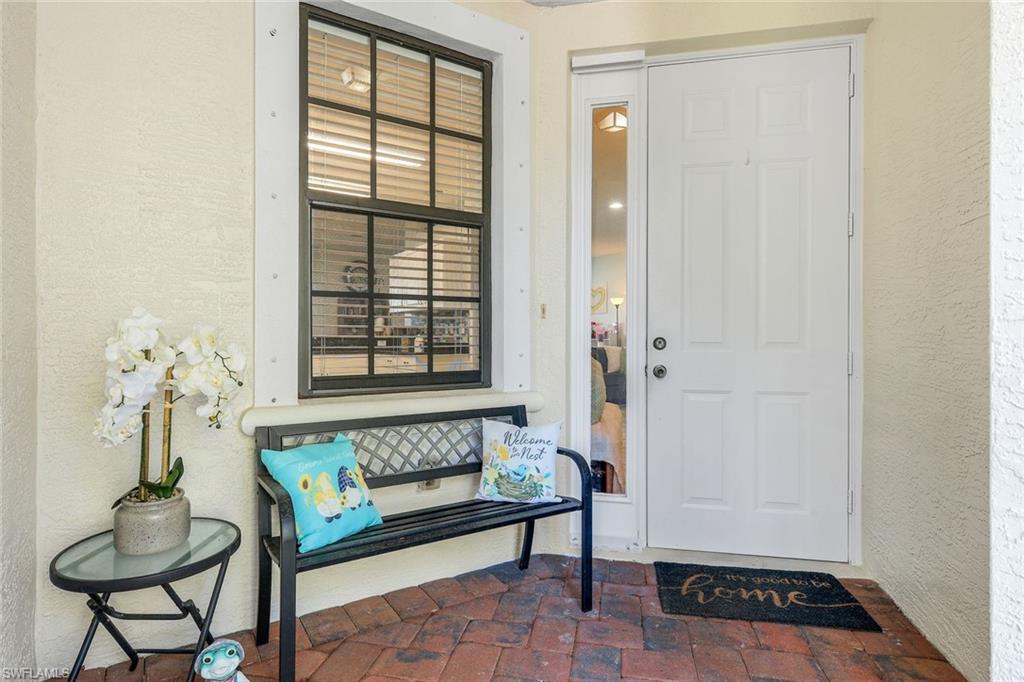 15239 Summit Pl Circle, Unit 246 Naples, FL 34119 - Photo 6 of 49 Entrance to property with stucco siding and a patio