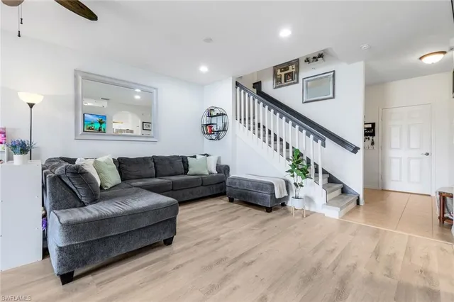 a living room with furniture and wooden floor