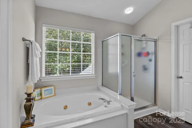 a bathroom with a granite countertop sink a large mirror and a window