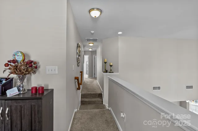 a front view of a house with a tree