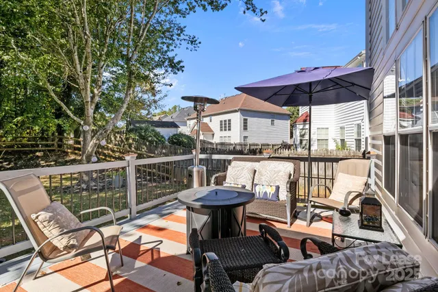 a view of a patio with table and chairs