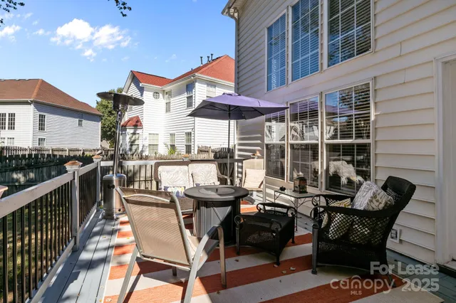 a view of balcony with wooden floor and seating space