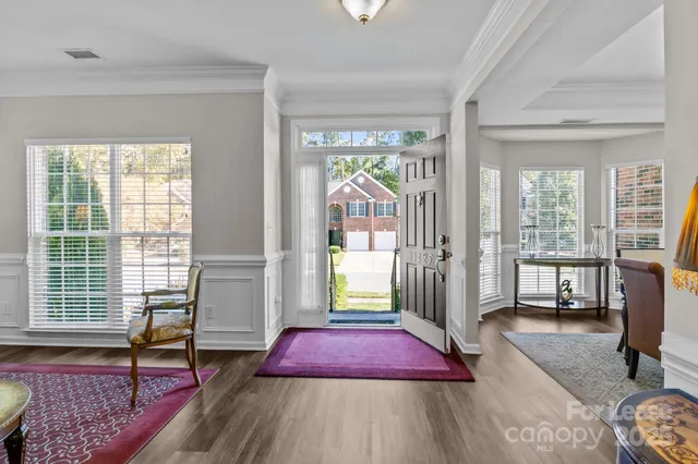 a living room with furniture a rug and a window