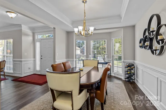 a living room with furniture a fireplace and a large window