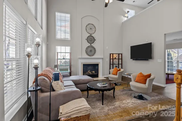 a living room with furniture a window and a fireplace