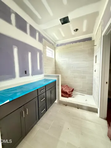 a view of a hallway with white walls and wooden floors