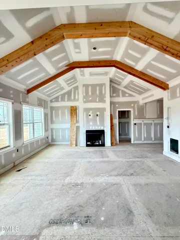 a view of room with window and mirror